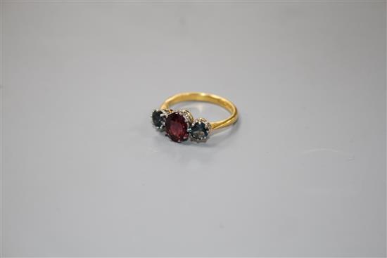 A 1930s 22ct gold, garnet and sapphire? three stone dress ring,